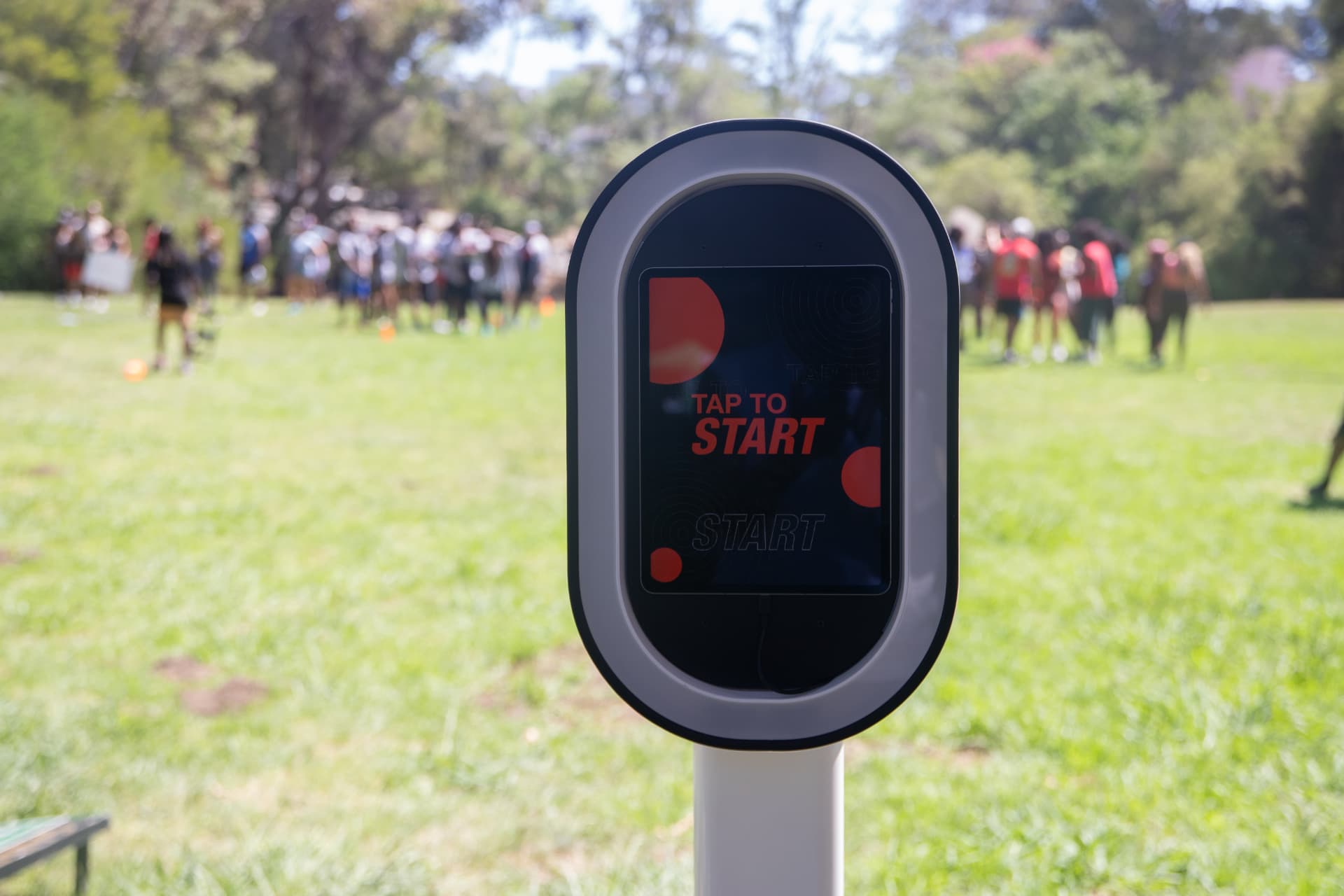 MOMNT roaming photo booth kiosk at an outdoor community field day